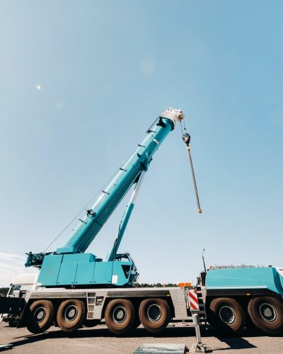 blue-crane-lifting-mechanism-with-hooks-near-the-glass-modern-building-crane-and-hydraulic-high.jpg