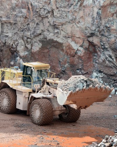 earthmover-in-an-active-quarry-mine-of-porphyry-rocks-digging.jpg